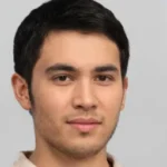 Young man with short dark hair and neutral expression.